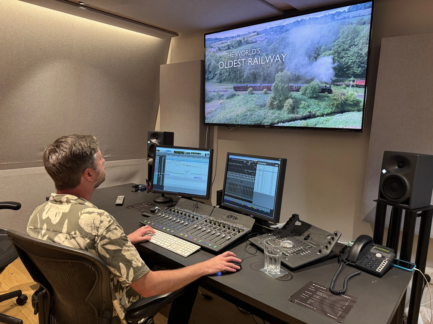 An editor at a professional post-production desk grading The World's Oldest Railway for BBC
