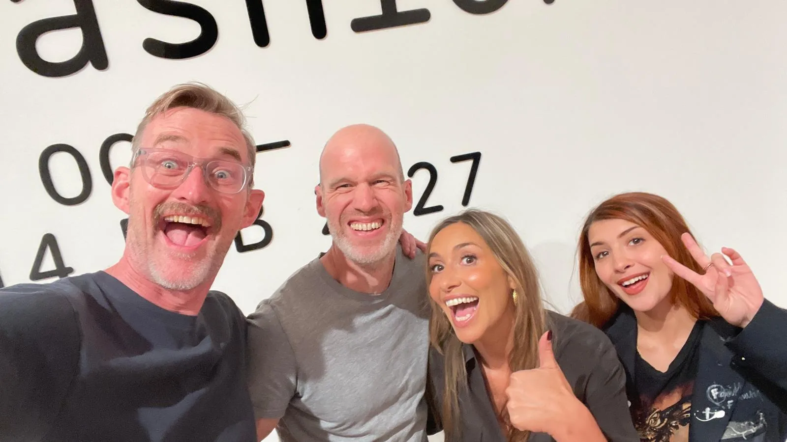 Four members of the crew grinning at the camera in a selfie behind the scenes on the Tate Britain shoot